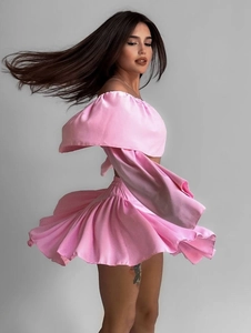 Dynamic side view of pink satin off-shoulder ruffle top and high-waist pleated skirt