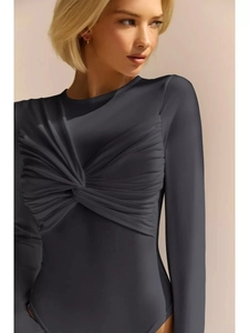 Detail of charcoal grey long sleeve bodysuit featuring front twist knot pleated design