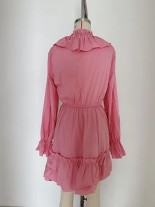 Detailed back view of a pink long-sleeve dress with ruffled collar and elastic waist hem