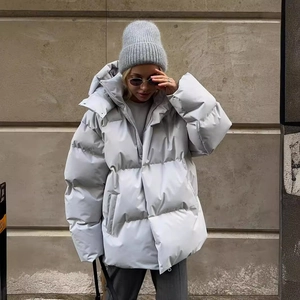 Women's light grey oversized hooded puffer jacket for winter street style look