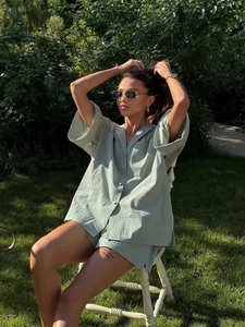 Chic sage green linen two-piece lounge set with short sleeve button-down shirt and shorts