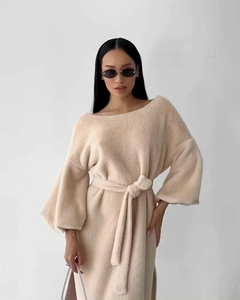 Detailed texture of beige plush knit dress featuring elegant waist tie and lantern sleeves