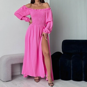 Detail of off-shoulder smocked dress with long lantern sleeves and side slit in rose pink