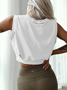 Detail of white crop top and olive green high waisted leggings for fitness workout