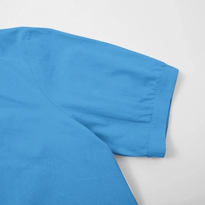 Detailed view of sky blue short sleeve shirt stitching and premium cotton fabric texture