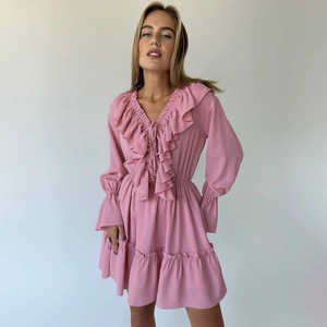 Detail of V-neck tie and ruffle trim on pink long sleeve dress for a sweet feminine style