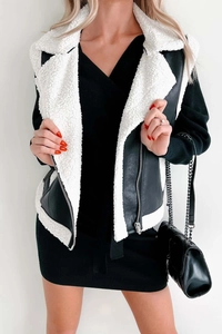 Detail of a chic faux leather vest with plush shearling collar and zipper accents