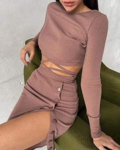 Detail of ribbed knit crop top with waist straps and side slit skirt in dusty pink