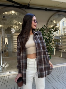Women's plaid flannel long sleeve shirt with beige crop top and white high waist pants