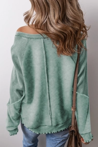 Macro detail of green waffle knit texture and vertical back seam on a vintage style shirt