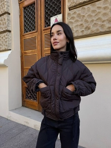 Detailed view of chocolate brown wavy quilted jacket with adjustable drawstring cuffs