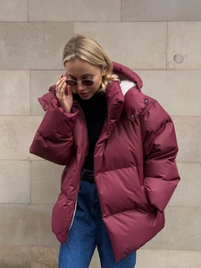Oversized burgundy puffer jacket with windproof high collar and white interior lining