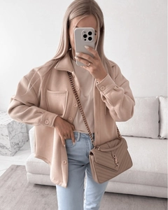 Detail of apricot wool shacket with flap pockets and high-waist jeans for casual chic style