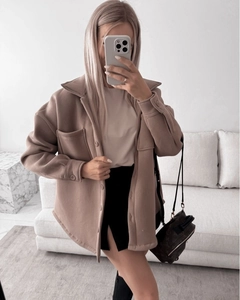 Detail view of camel oversized shacket with lapel collar and flap pockets on chest