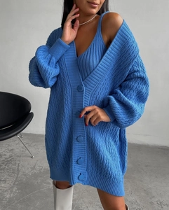 Detail of bright blue cable knit cardigan with lantern sleeves and matching camisole set