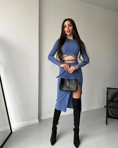 Detail of blue-purple knit two-piece set featuring waist wrap-around ties and side split skirt