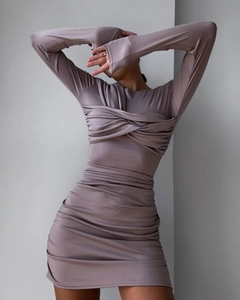 Close-up of the elegant twist knot design and ruched fabric on the dusty pink mini dress