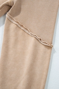 Detail of camel waffle knit and jersey fabric stitching with raw edge finish on T-shirt