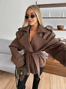 Detail of a brown wool coat featuring oversized lapels, epaulets, and a belted waist