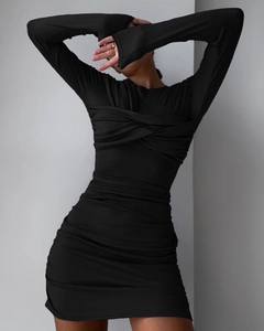 Detail of the cross-knot neckline and ruched texture on a slim-fit black long sleeve dress