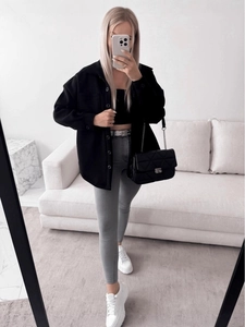 Women's oversized black wool shirt jacket with gray slim trousers and platform sneakers