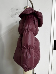 Detailed side view of wine red hooded puffer jacket with quilted padding and glossy fabric