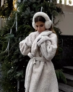 Detail of white faux fur winter coat waist tie and plush texture for women