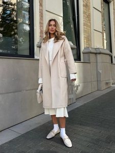 Elegant beige wool coat with lapel collar and waist tie for a minimalist winter look