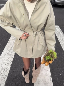 Beige hooded trench coat with adjustable drawstring waist and large utility pockets