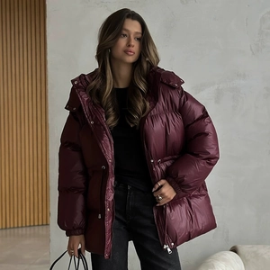 Detail view of burgundy padded coat with silver zipper and drawstring hood