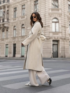 Chic off-white long wool coat with waist tie and lapel collar in minimalist urban style