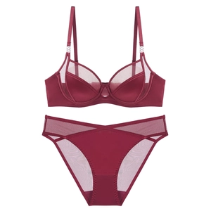 Detailed view of burgundy satin and sheer mesh lingerie set with metal ring accents
