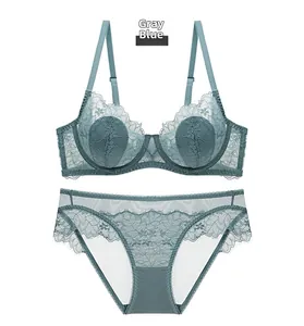 Flat lay of gray blue sheer lace lingerie set with underwire bra and matching panties