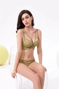 Detail of green eyelash lace lingerie set featuring a halter bra and cutout panties