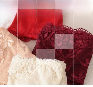 Detail von buntem floralem Spitzenstoff mit Stickerei und gewellten Kantenmustern