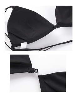 Detalle del cierre delantero y copas triangulares de un bralette negro de tirantes finos