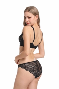 Detail of black lace bra back closure and floral eyelash lace panties on a female model