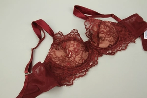 Detailed close-up of wine red floral eyelash lace on the bra cup and satin straps