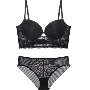 Elegant black floral lace bra and panty set with adjustable straps on white background