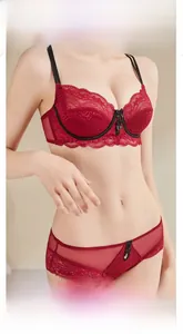 Close-up of red floral lace bra with black straps and matching breathable mesh panties