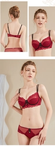 Detail view of burgundy lace lingerie set with fine mesh and black bow accents