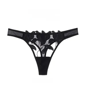 Close-up of black lace thong featuring intricate floral embroidery and sheer mesh details