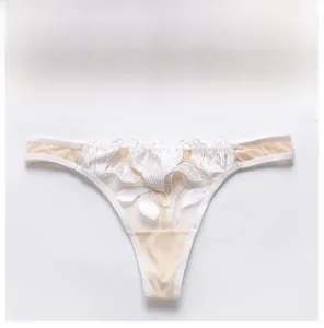 Detail of white floral lace embroidery on sheer mesh thong for breathable comfort