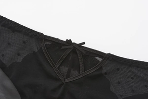 Detail of black mesh bra with heart embroidery and dainty ribbon bow decoration