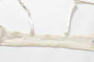 Detailed macro view of adjustable straps and breathable mesh fabric on lace bra