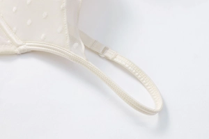 Detail of breathable mesh lace bra with embossed polka dots and fine stitching