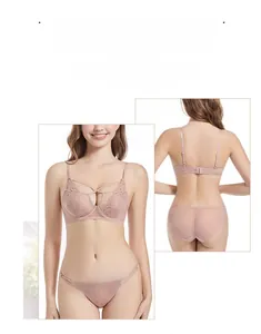 Detailed view of pale pink lace lingerie set with X-cross front design and floral patterns