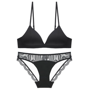Sexy black wireless triangle bra and lace mesh panty set in a flat lay display