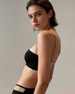Detail view of seamless backless bra with ultra-thin black straps and smooth finish
