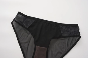Detailed close-up of breathable black mesh fabric and delicate eyelash lace embroidery